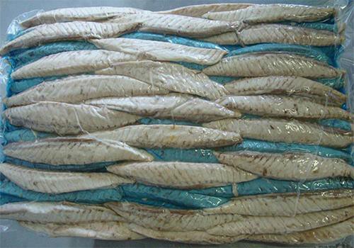 Precooked Pacific mackerel meat arranged in a lined carton