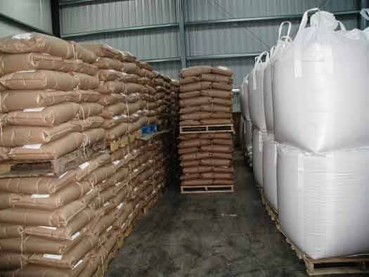 Black pepper packed in bags and big bags stacked in an export warehouse